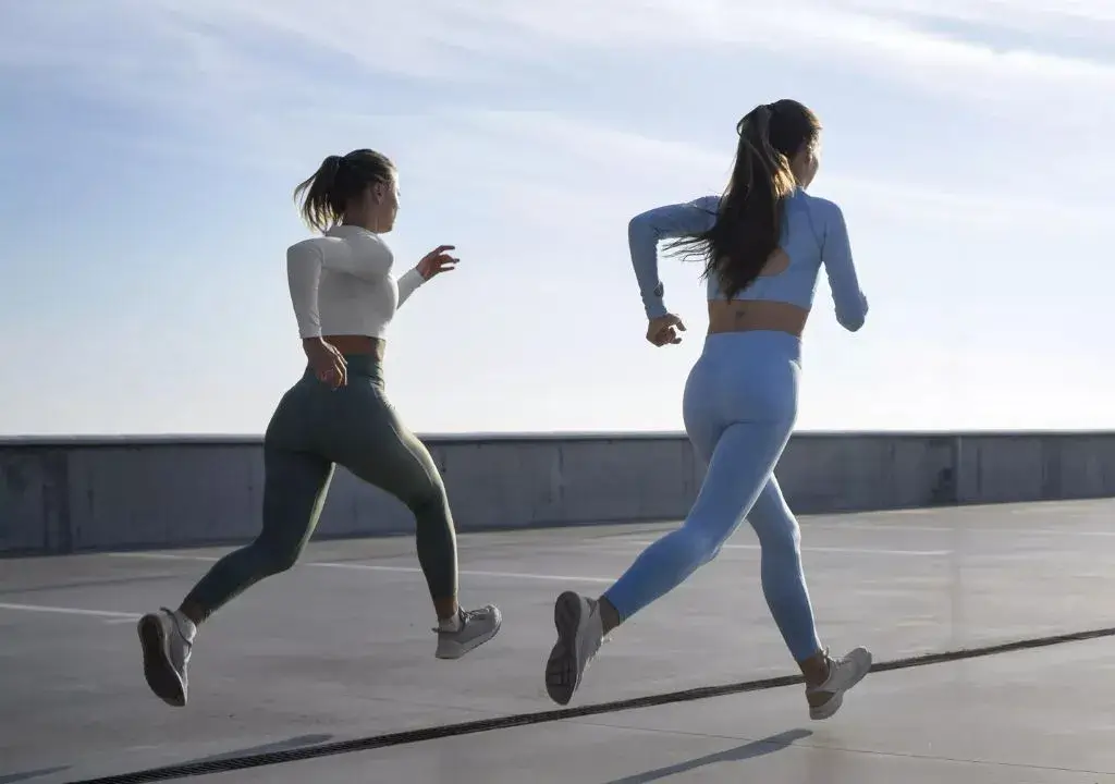 2 women running together
